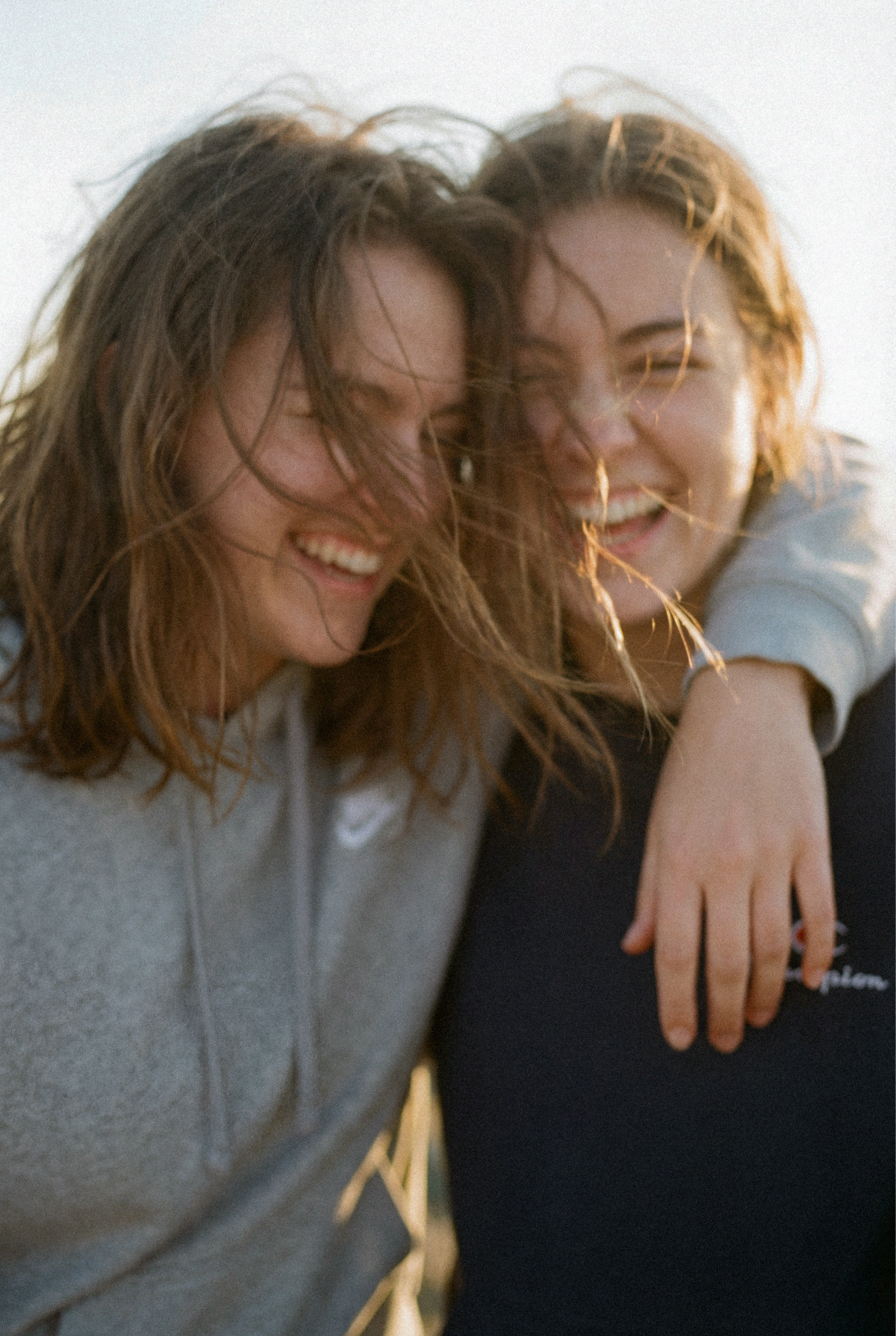 Two woman laughing in the sunlight