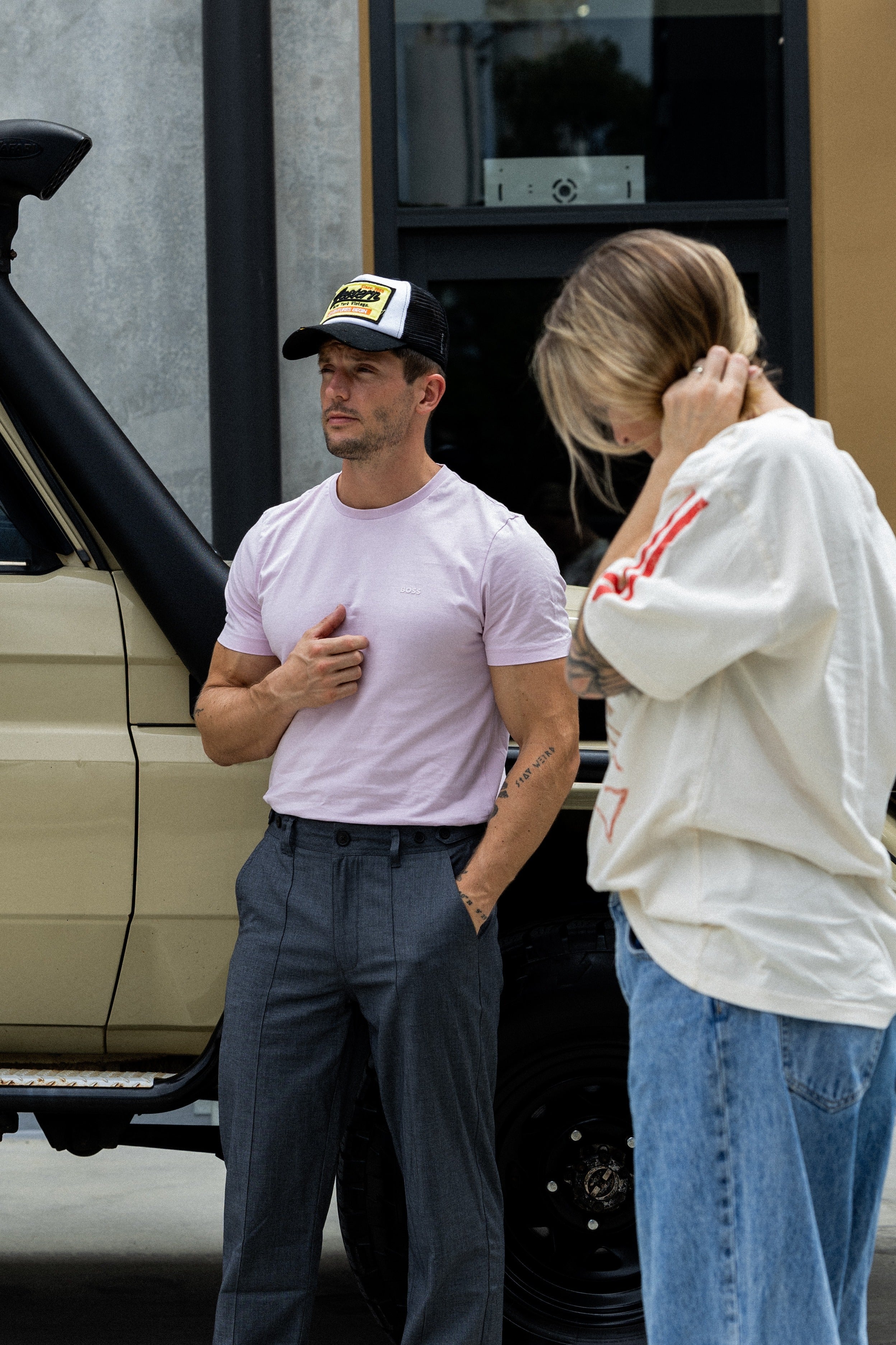 Woman and man standing on street not talking