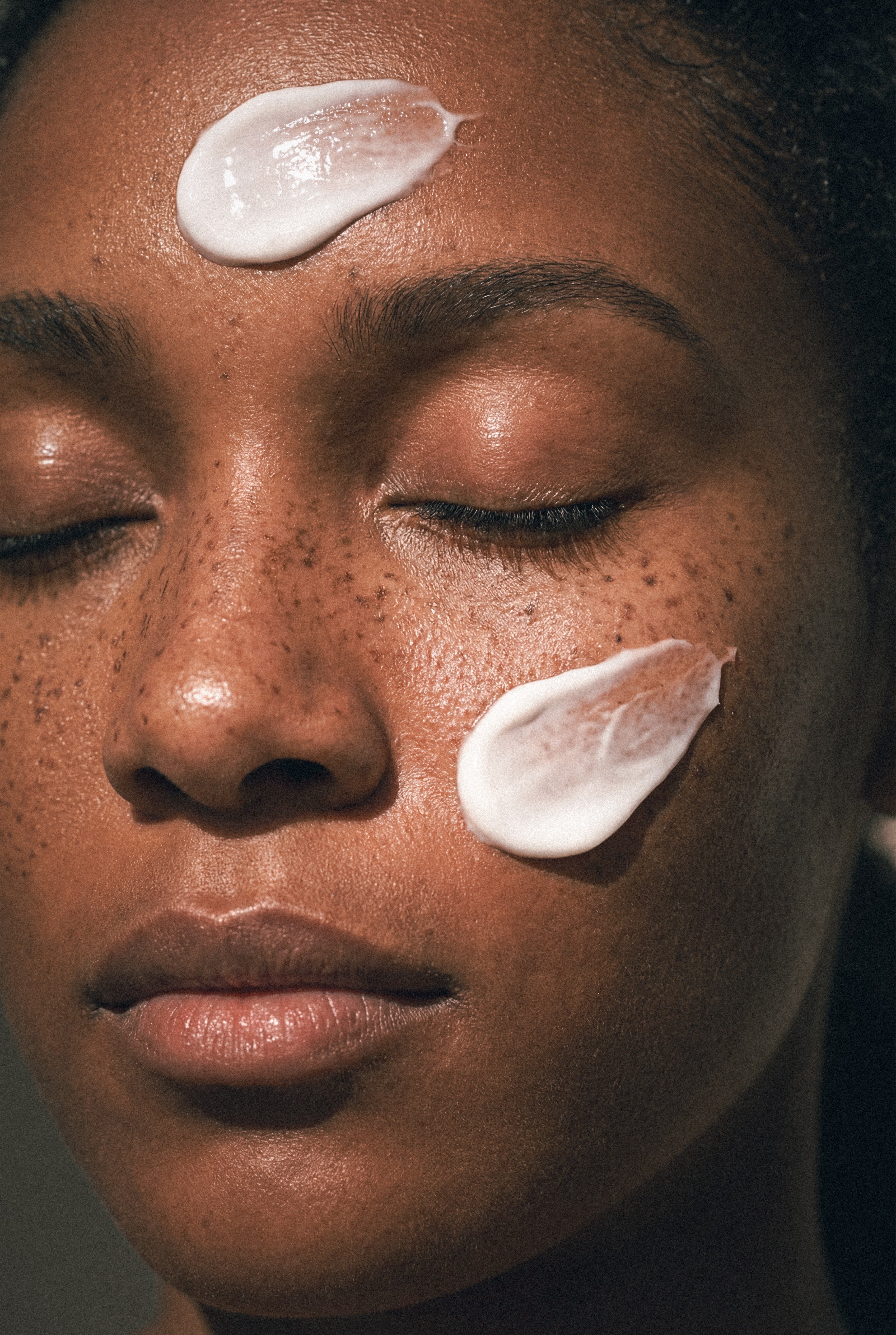 Close up of woman's face with cream on it 