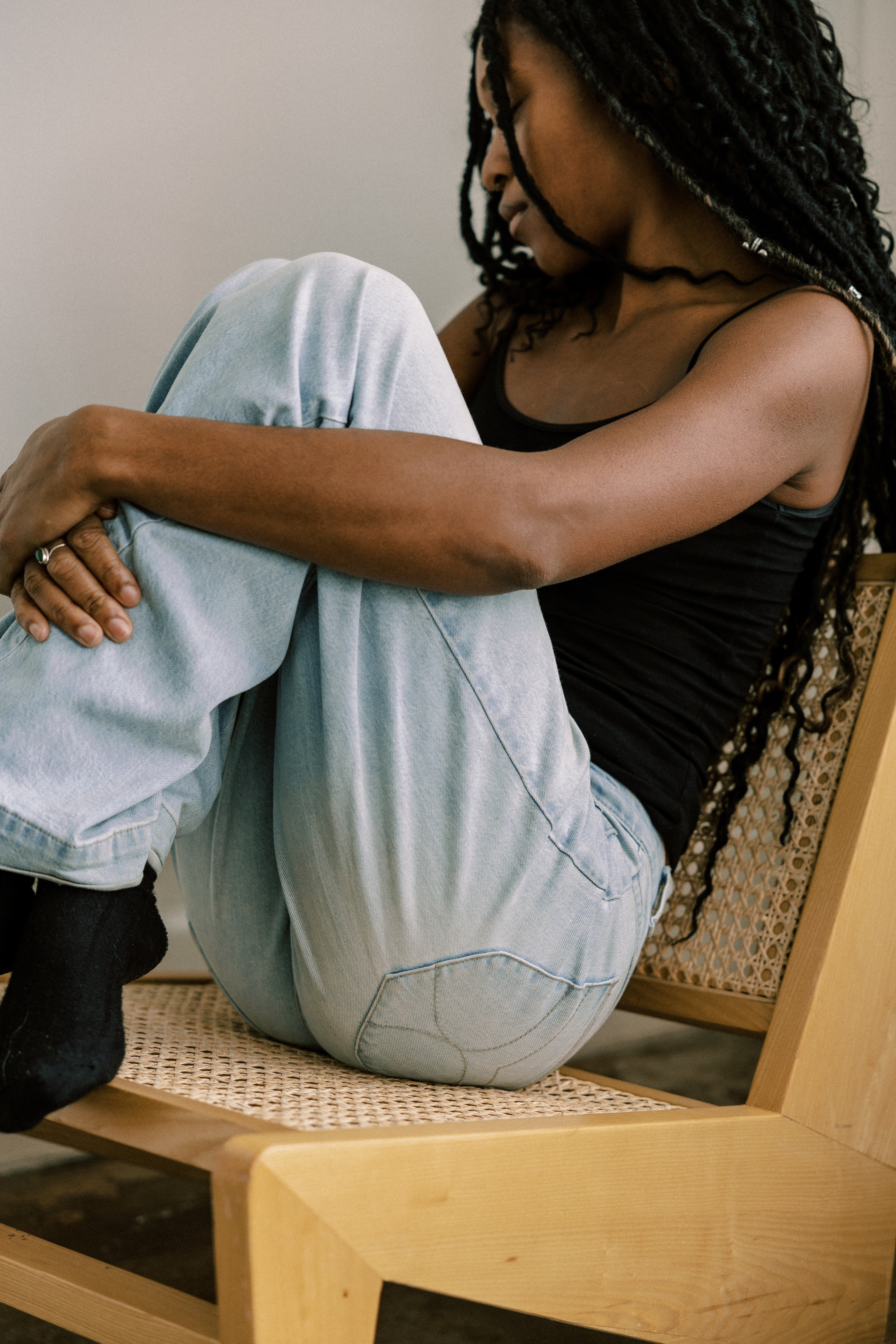 Woman sitting on chair looking sad