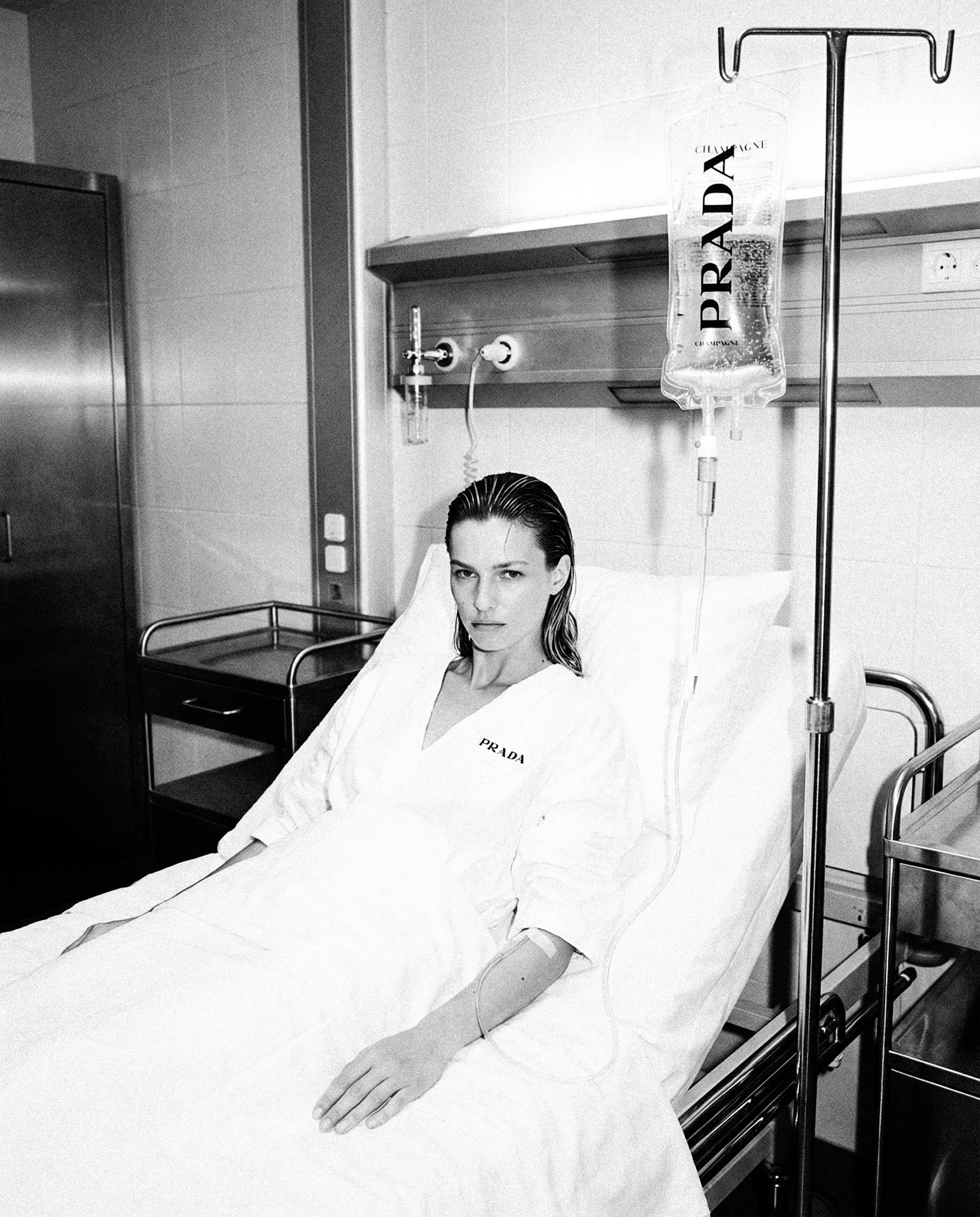Woman with Prada IV in hospital bed